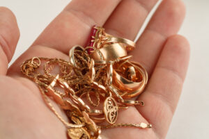 Pile of gold jewellery in hand, closeup shot