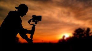 Silhouette,Of,Videographer,Is,Filming,With,Cinema,Gimbal,Video,Dslr