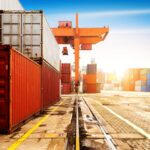 36062686 - the container terminal at dusk, a large crane work.