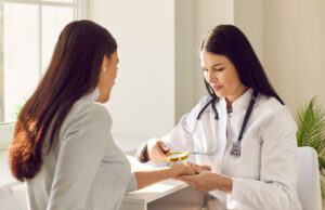 Female,Friendly,Doctor,Examining,Hand,Skin,Of,Young,Woman,Patient.